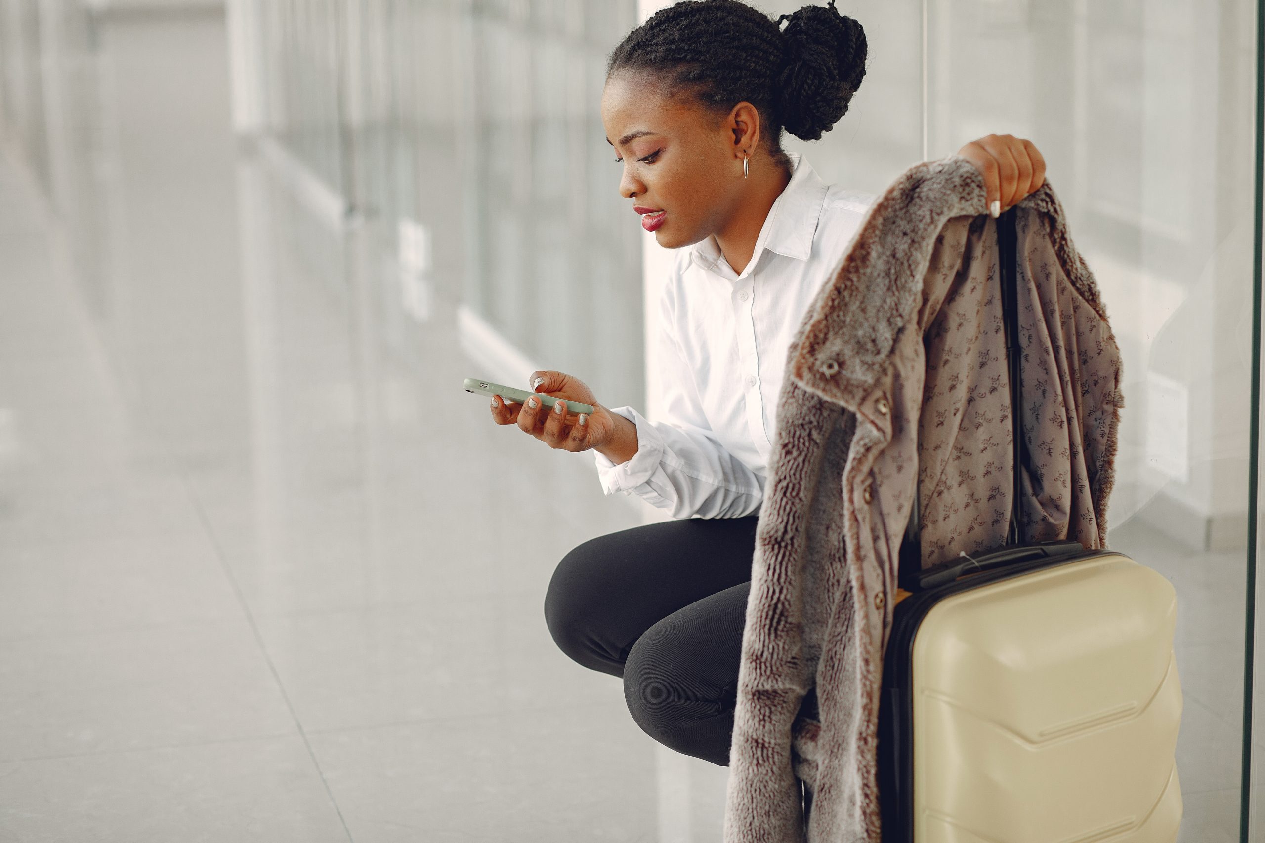 black woman with suitcase at the airport scaled