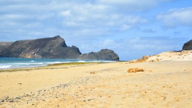 breathtaking view of porto santo beach with a huge rock formation