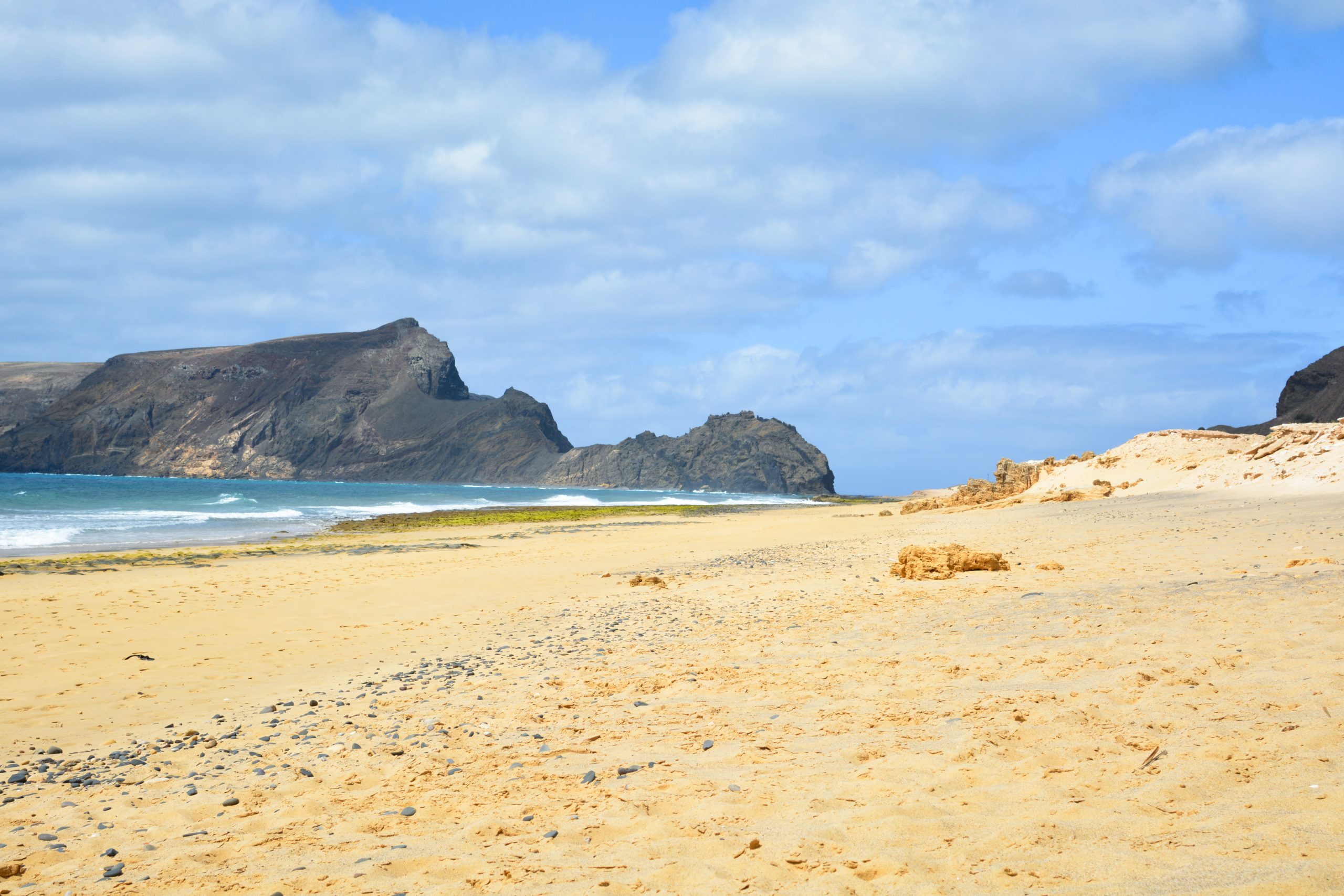 breathtaking view of porto santo beach with a huge rock formation scaled