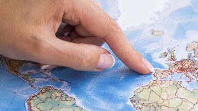 woman pointing at portugal on the map