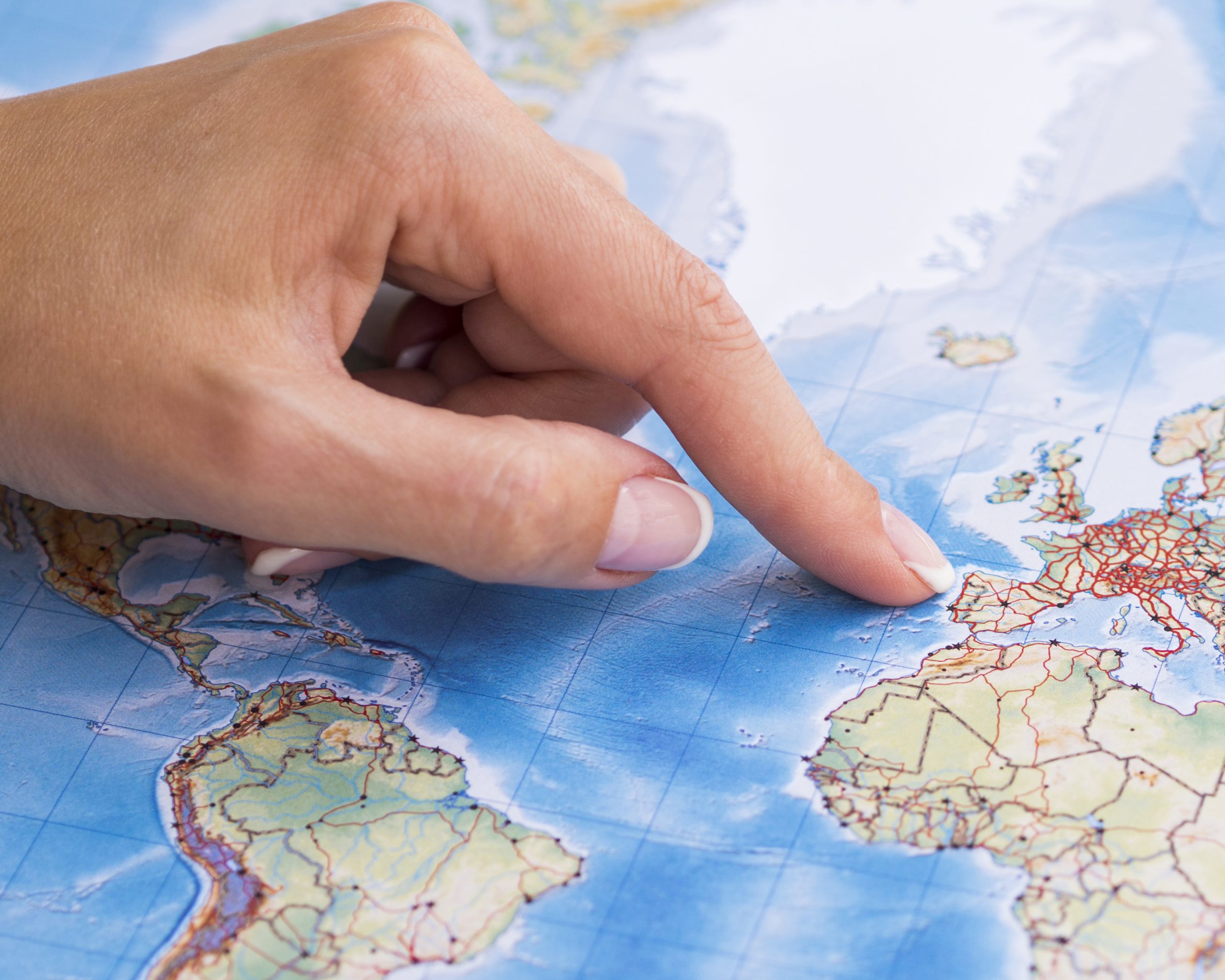 woman pointing at portugal on the map scaled