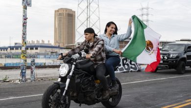 couple on a motorcycle with mexican flag