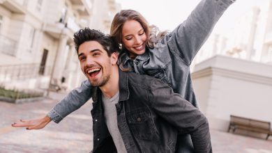 excited man in black denim jacket chilling with girlfriend outdoor portrait of happy couple exploring city